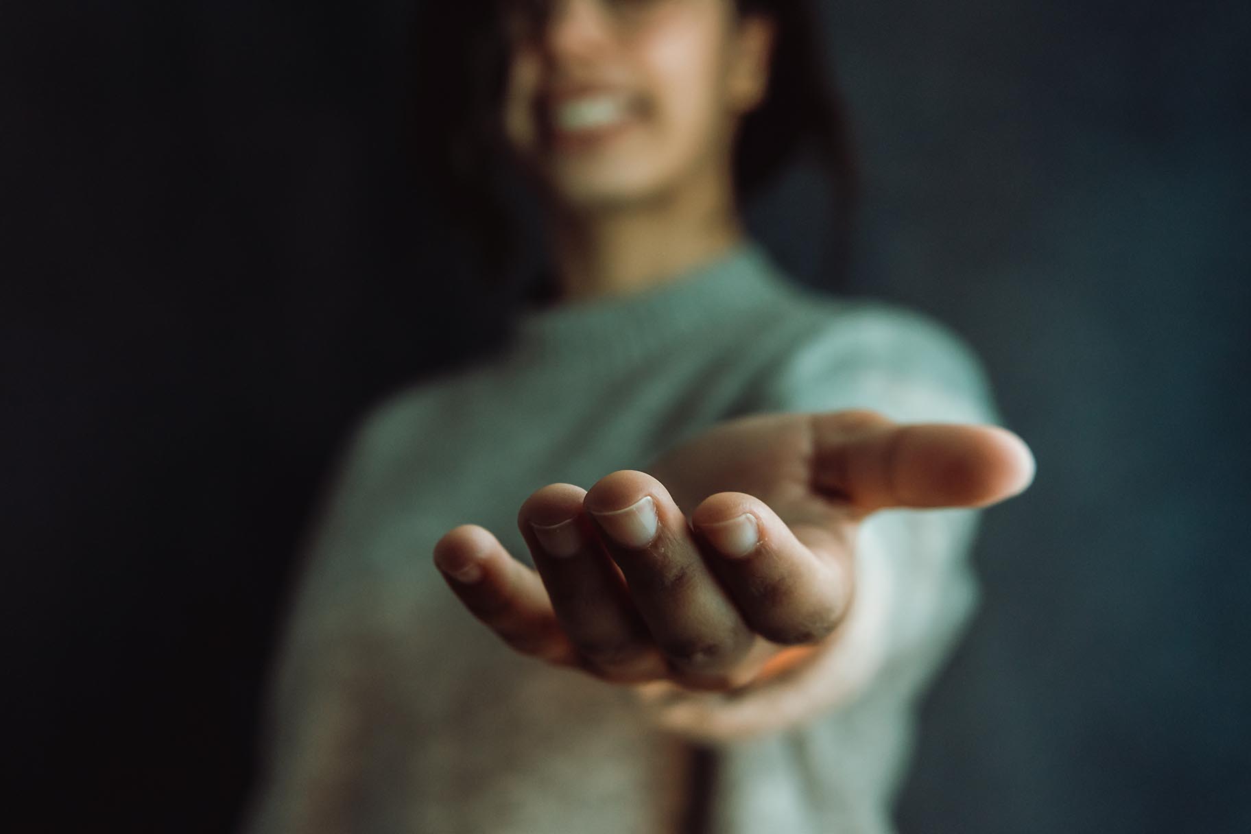 person reach out with open hands welcoming inviting